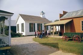 the outside of a historic school building and store from Old Alabama Town 