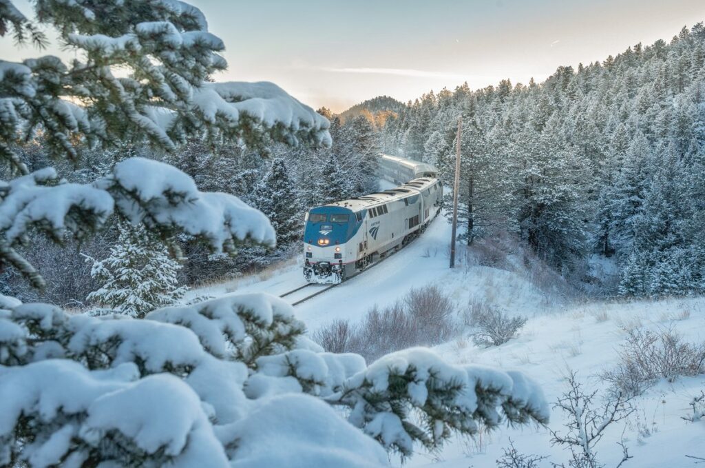 winter snow scenery with a passenger train on the railroad