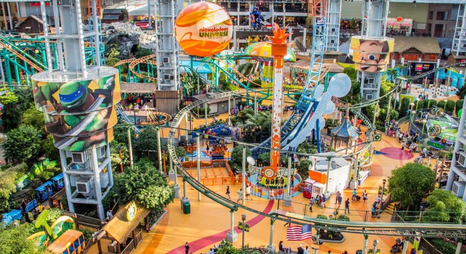 An indoor playground with rails winding around for a roller coaster ride.