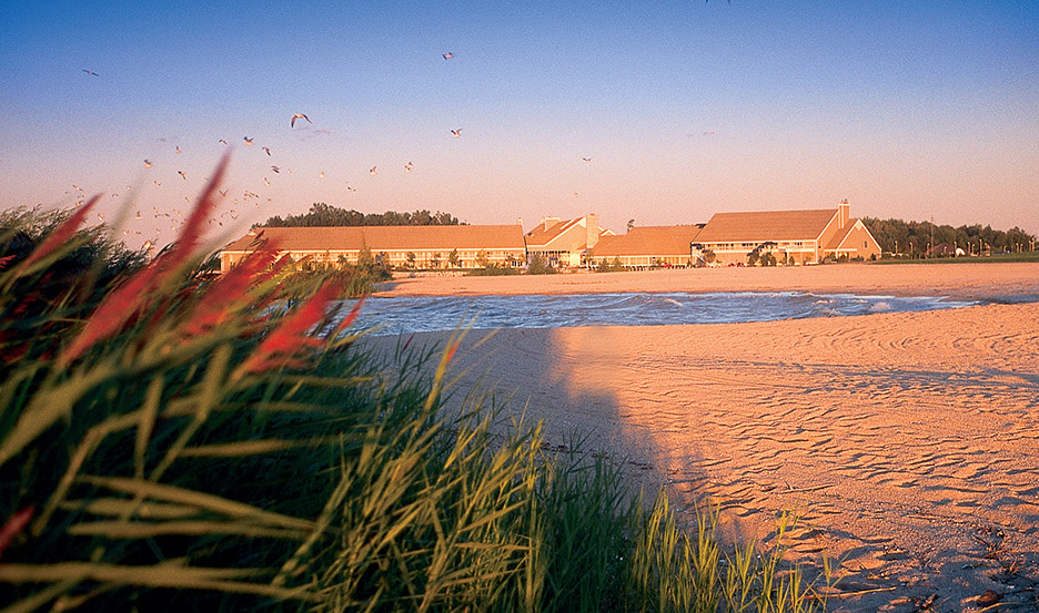 A view of Maumee Bay Resort Lodge and Conference Center with sandy beach in the forefront