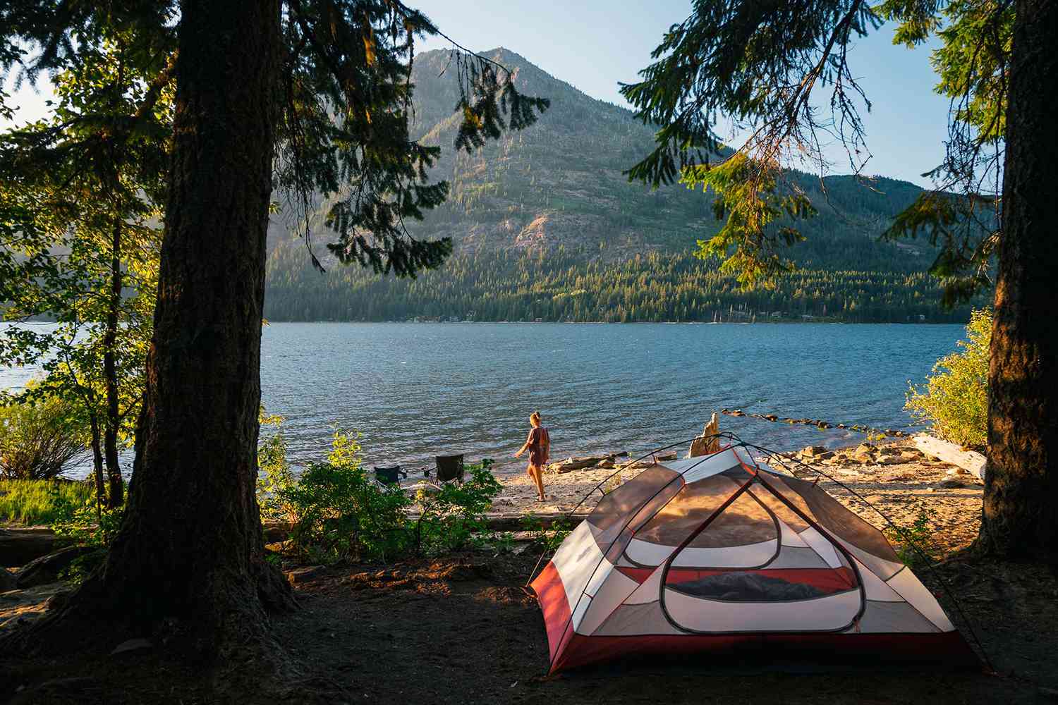 A lake with a single peaked mountain in the background