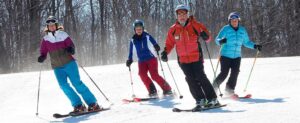 Four people skiing at wachusett