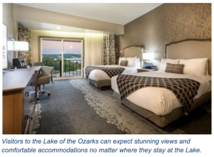 Inside a Lake of the Ozarks hotel featuring two beds and a sunset out the window 