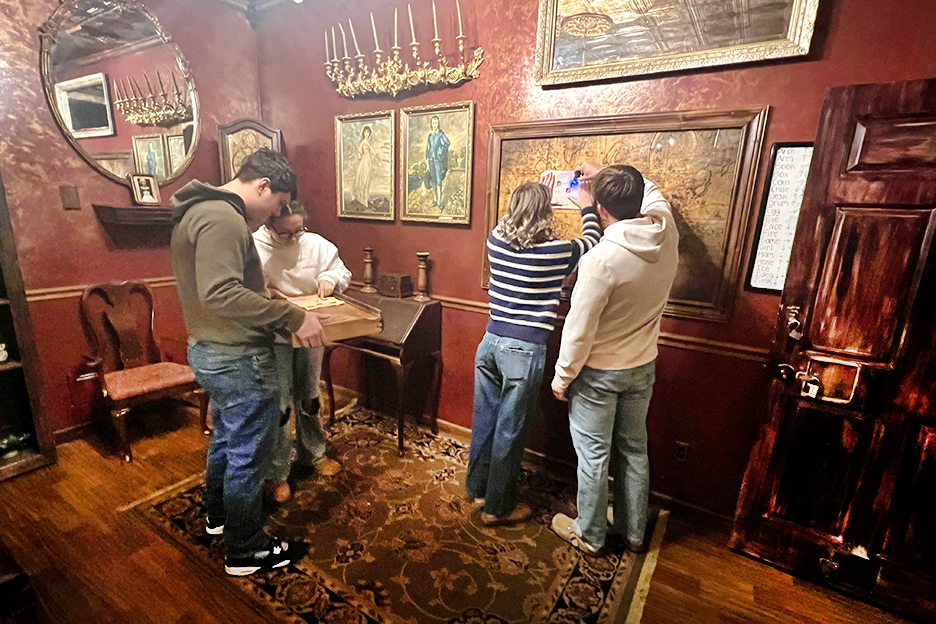group hunting for clues in an escape room game