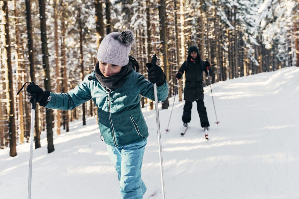 two kids cross-country skiing