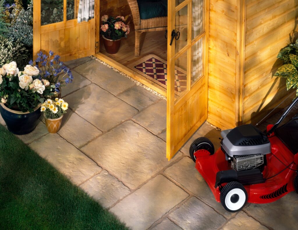 red push lawnmower at the side of a wooden porch door