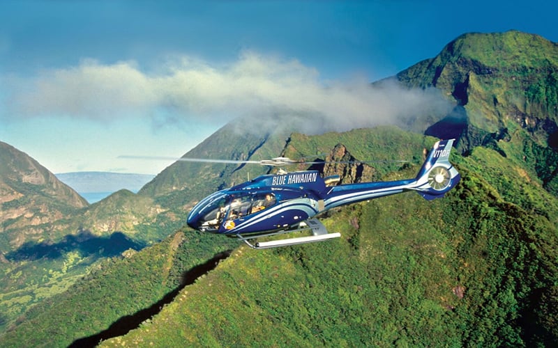 A helicopter flying over mountains