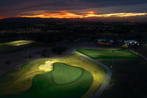 Rolling Hills Golf Course lit up at night with a sunset in the background