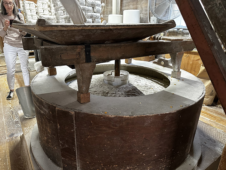 an antique grinder inside an old mill