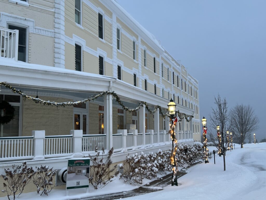 exterior of a two story colonial building in winter with snow on ground