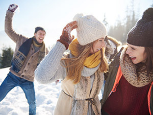 Adults playing outdoors in snow