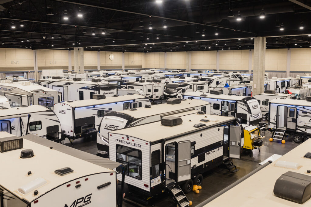 showroom in an arean of new RVs on display