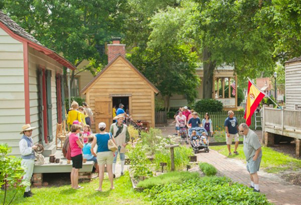 A family crowd of visitors exploring the historic buildings at History Village in Pensecola