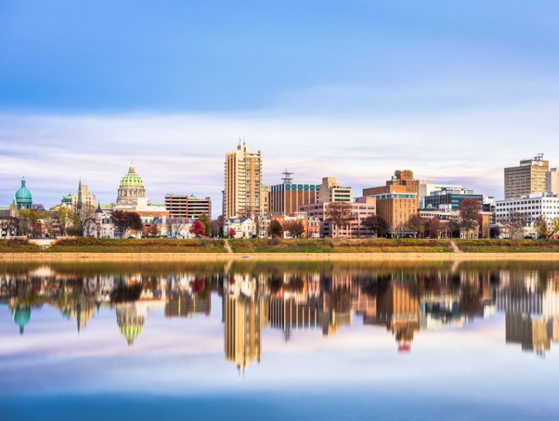 city skyline showing reflection ins water blow