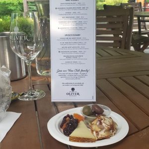 A plate of food staged in front of a long menu at a restaurant