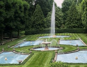 6 various fountains arranged in a well mowed lawn