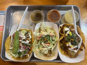 Three different tacos on a tray