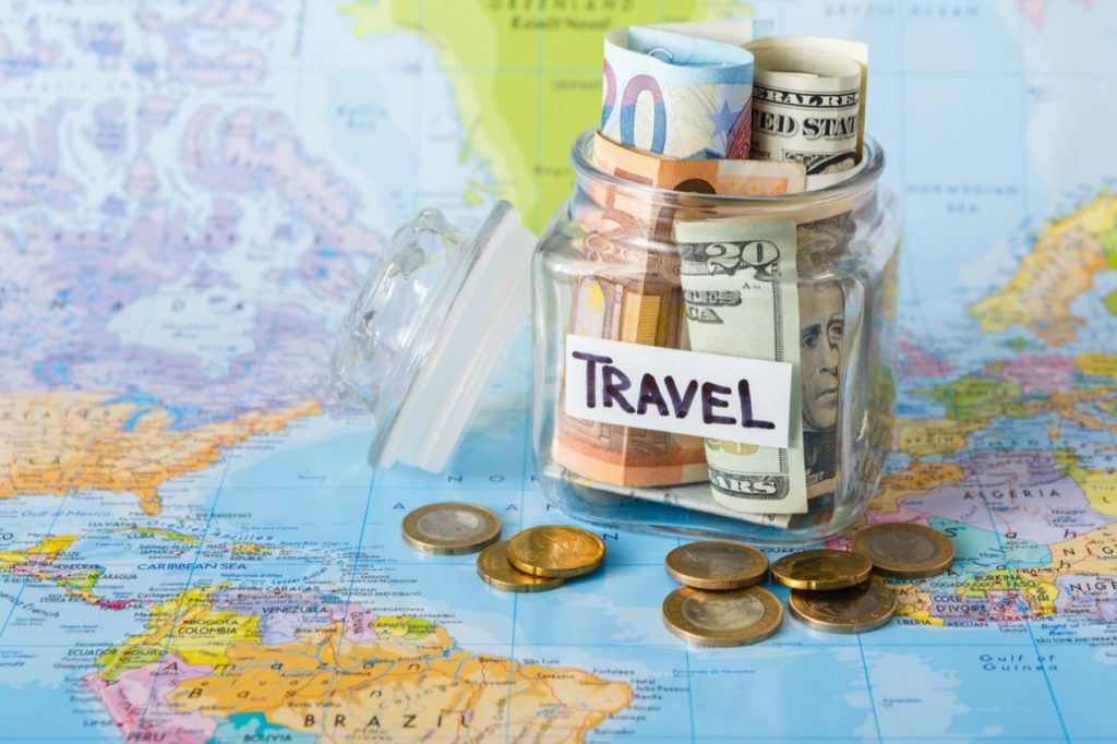 Travel money jar sitting on a map
