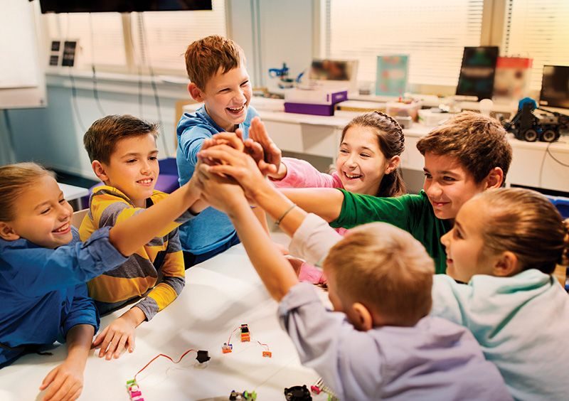 Group of students high-fiving