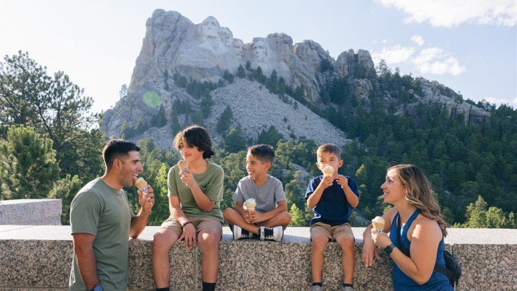 Family eating ice cream in front of Mount Rushmore National Memorial
