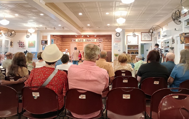 A seated audience facing a music stage at Floyd Store, Bristol VA