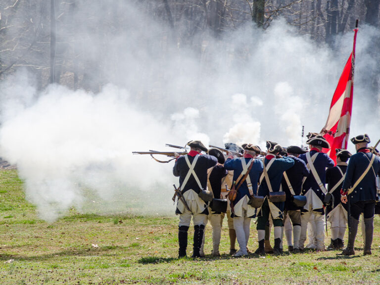 re-enacting solders from the Revolutionary war shoot rifles
