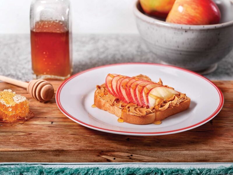 Plate of French Toast with layers of apples on top.