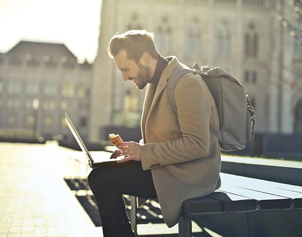 Someone working on a laptop while traveling