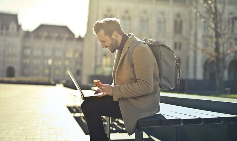 Someone working on a laptop while traveling