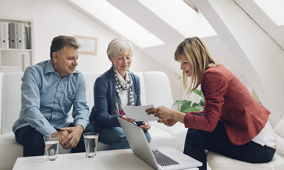 A couple meeting with a CFP Professional to help with budgets