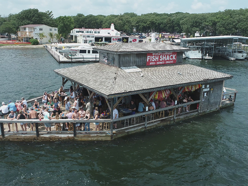 Aerial view of the Fish House restaurant looking like a houseboat on water.