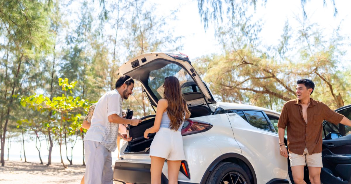 a couple packing a car for a roadtrip