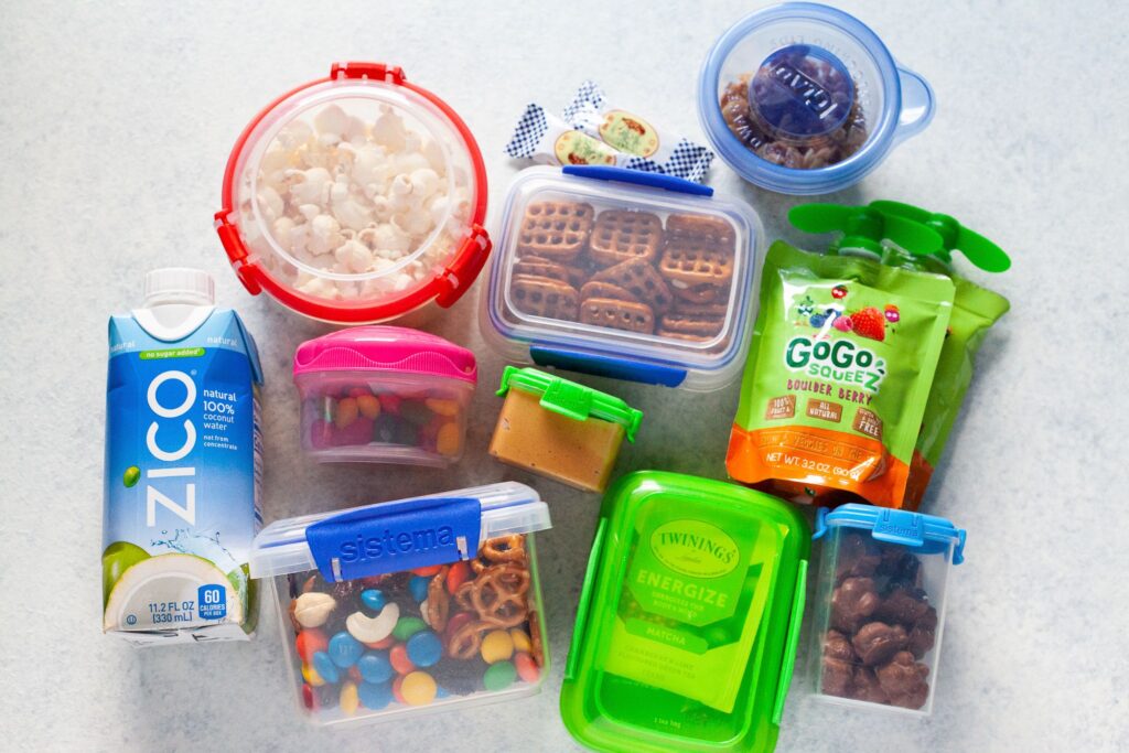 collection of snacks in bags and containers
