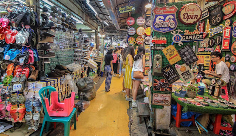 ladies shoping in a crowded store with yellow long isle down the center
