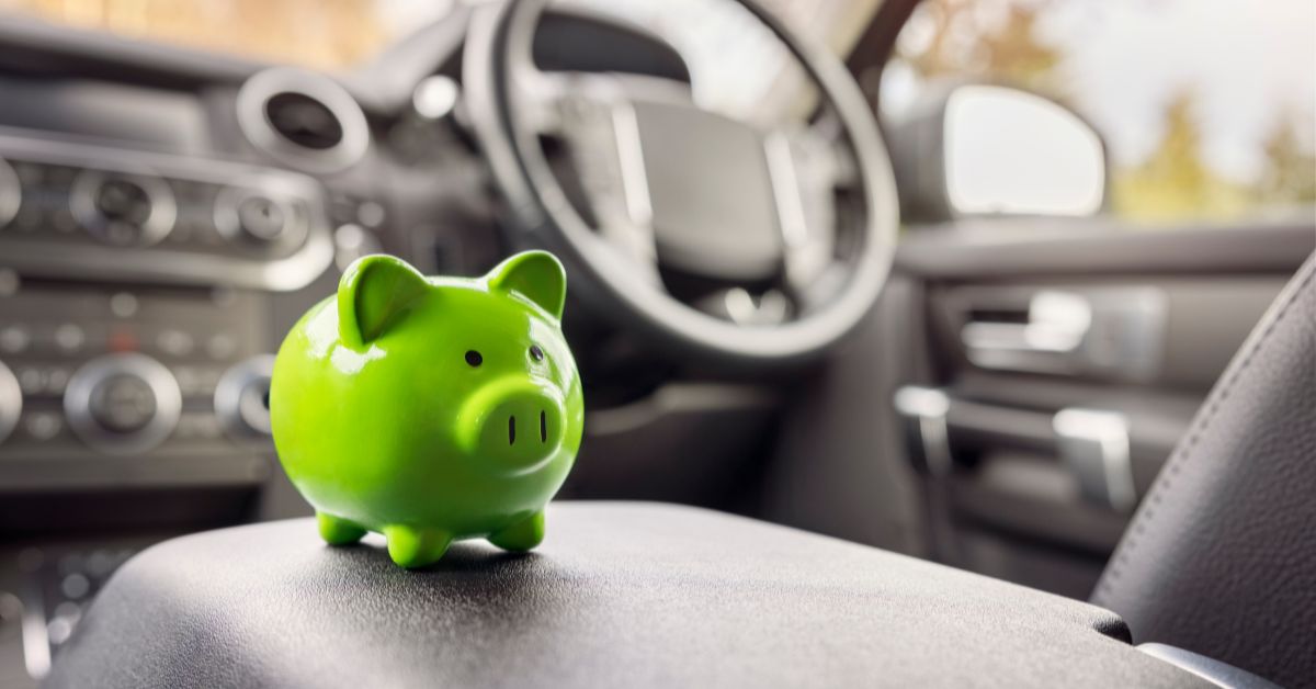 Green piggy bank inside a car