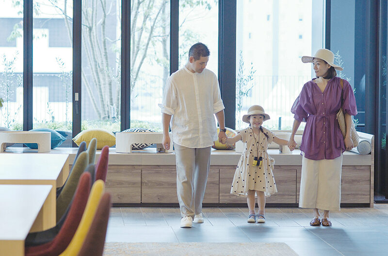 Family holding hands inside a Hyatt Hotel