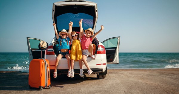 Kids sitting in the back of a car for a photo op