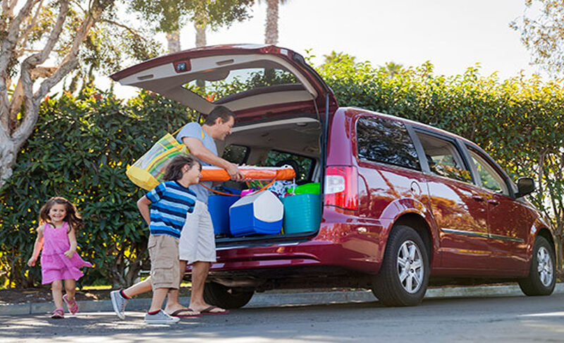 Family loading up a van before a trip.
