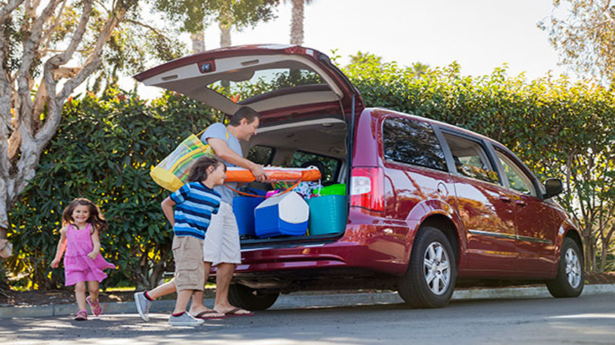 Family loading up a van before a trip.