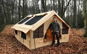man standing in front of a tent with windows