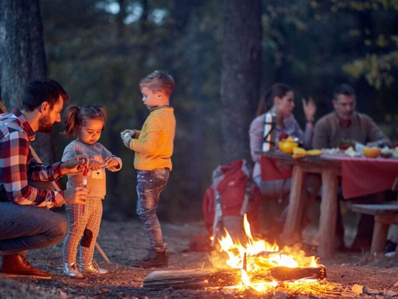 family outside around a campfire