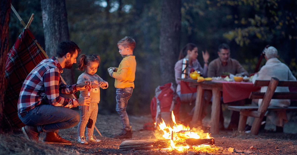 family outside around a campfire