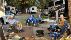 Campers sitting around socializing outside of their RV's