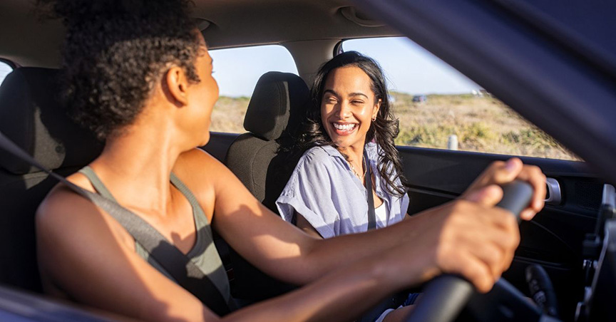 Someone driving in a car with a friend on a road trip