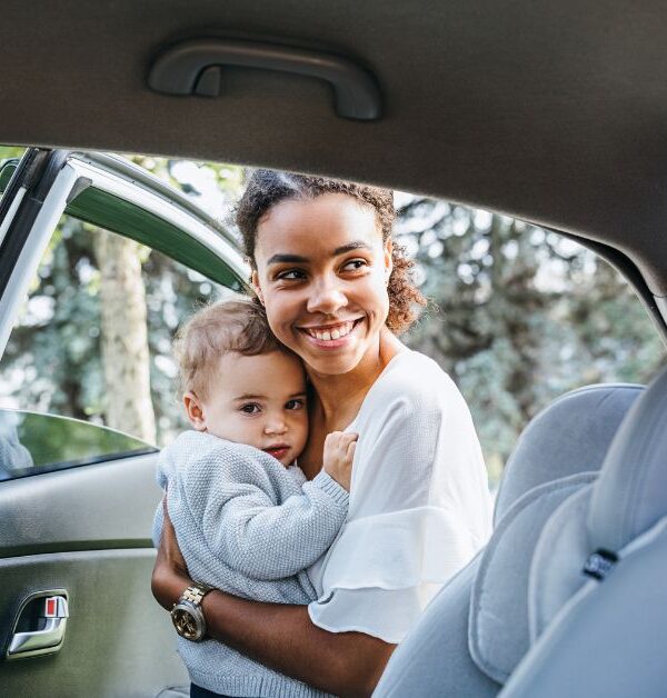 Mother putting baby in the car