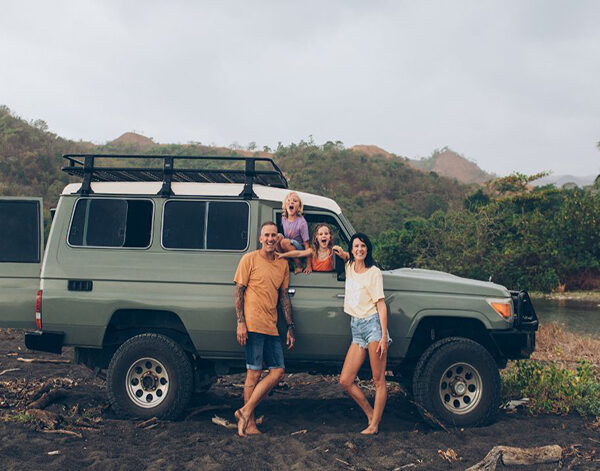 Family standing by their car
