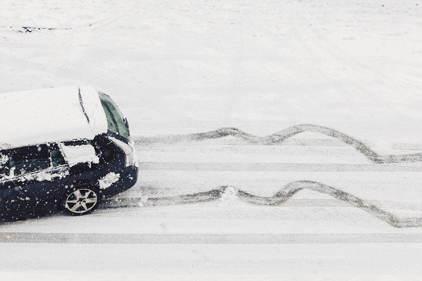 a car sliding in snow on the road sideways