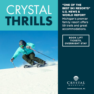 A snow skiier dressed in blue with destination of CRYSTAL THRILLS written above.