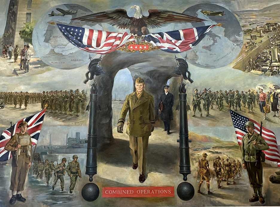 a painted mural of a bald eagler spread of the U.S. flage, above an army solder with armed forces in the background on duty