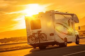 RV facing a bright sunrise